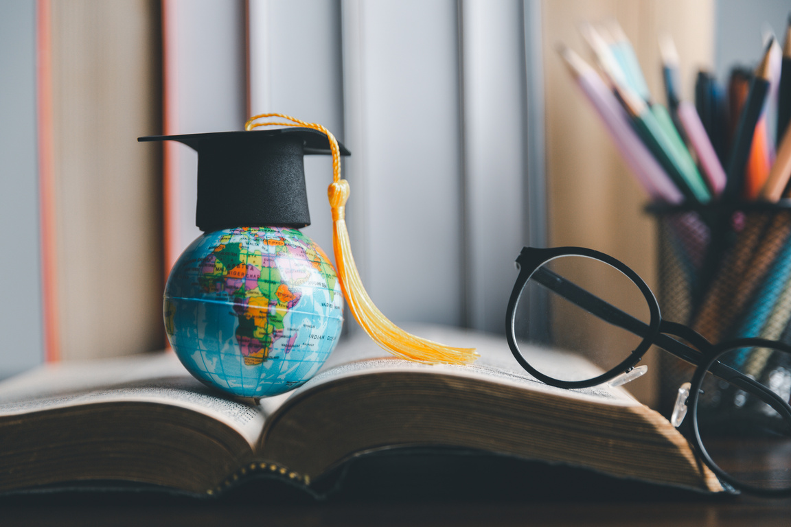 Graduation cap with Earth globe. Concept of global business study, abroad educational, Back to School. Education in Global world, Study abroad business in universities in worldwide. language study